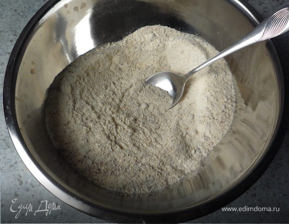 В отдельную емкость просеять муку, добавить крахмал, орехи и разрыхлитель. Перемешать. Добавить мучную смесь к шоколадной массе. 