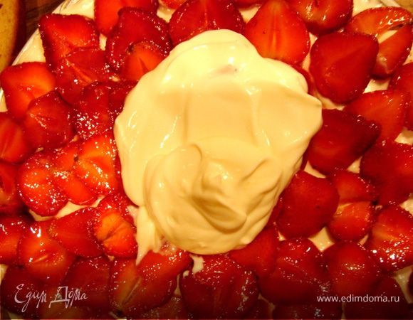 Если у вас жидкая сметана,то надо подвесить её в марле на 1 час.Затем взбить её с сахарной пудрой.Остывший корж разрезать пополам и пропитать соком от засахаренных ягод.На нижний корж нанести половину крема,затем выложить ягоды и опять крем.Накрыть вторым коржом.  