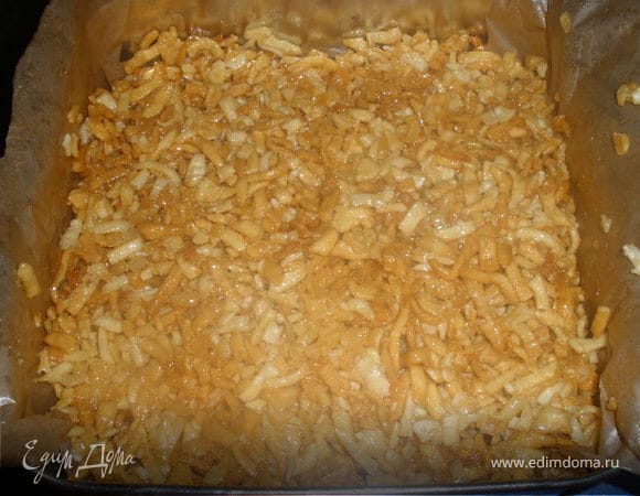 Снять сироп с огня и засыпать в него подготовленную обжаренную лапшу и тотчас же — маково-ореховую смесь: все быстро и равномерно перемешать. Переложить горячий чак-чак в смазанный маслом противень слоем 2,3 см (это можно сделать руками, смоченными в холодной воде). Когда чак-чак остынет, нарезать его ромбиками или квадратиками. 