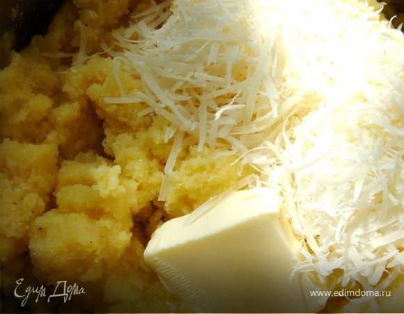 В кипящую подсоленную воду всыпать кукурузную муку и энергично размешивать,пока каша не станет очень густой.Добавить сливочное масло и пармезан.