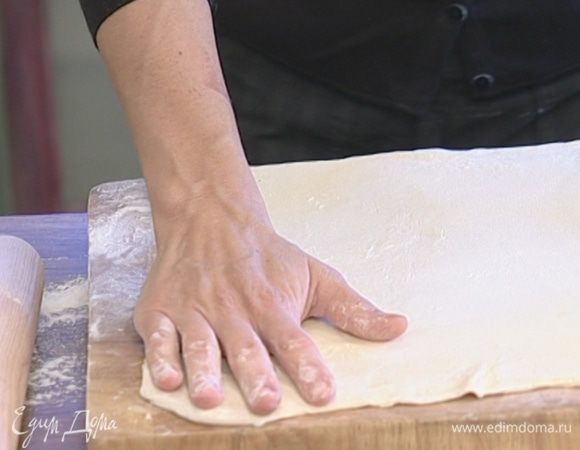 Посыпать поверхность стола мукой, раскатать тесто.