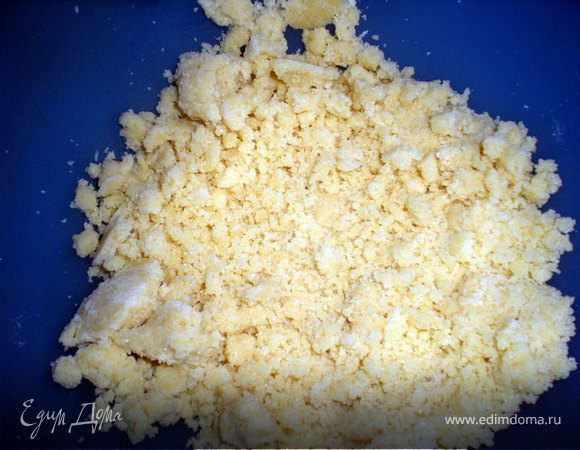 Охлажденный маргарин натереть на тёрке,периодически присыпая мукой.Добавить сахар,разрыхлитель и оставшуюся от присыпания муку.
Растереть руками в крошку.