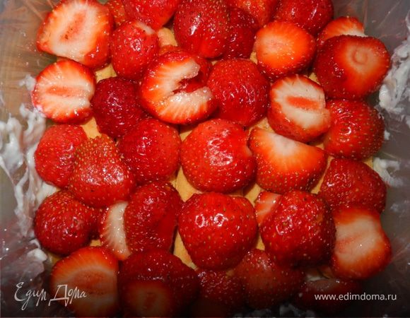 Клубнику и банан порезать. На печенье выложить слой клубники.