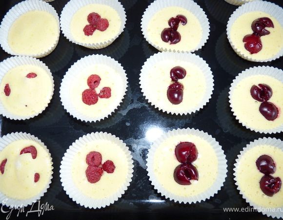 Подготовить ягоды, у вишни удалить косточки. В бумажные формочки положить по 1ст.ложке теста, добавить немного ягод, полить небольшим количеством мёда и снова выложить немного теста. Выпекать в духовке 180гр. 30 минут.