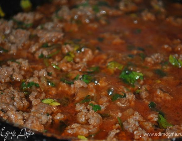 Пока подходит тесто, приготовим начинку: Лук почистить и порезать кубиками. Капусту нашинковать. Обжарить на раст. масле луковицу, добавить фарш и хорошо обжарить. Добавить томатный сок и зелень. Посолить, поперчить и протушить на медленном огне минут 10, чтобы вся жидкость испарилась. Остудить. 