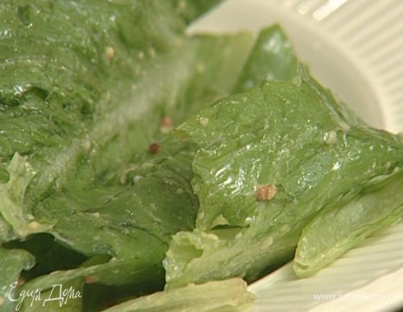 Листья салата сбрызнуть заправкой, перемешать.