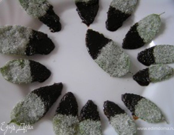 Листья мяты окунать в растопленный шоколад на половину их длины, затем выкладывать на блюдо. Убрать в холодильник на 1 час.