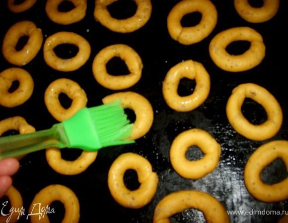 Противень смазать масло и уложить бублики, помазать каждый молоком