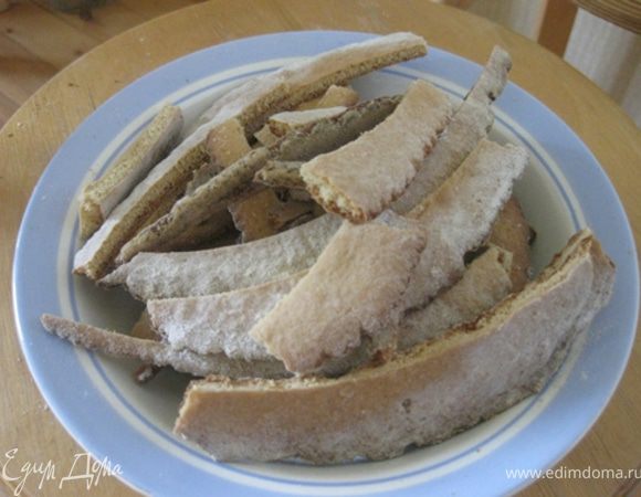 Корж после выпечки сначала ещё мягкий, поэтому нужно осторожно его выкатить с противня на стол. Затем посыпать снова противень мукой и выпекать следующий корж. Пока готовый корж не остыл, его нужно обрезать по вашему трафарету. В горячем виде лучше режется, да и крошек меньше. 

Обрезки складывать в отдельную тарелочку.
