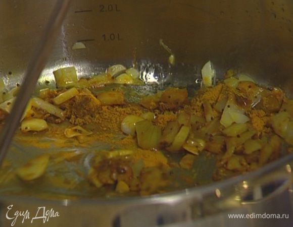 Разогреть в глубокой тяжелой сковороде растительное масло, обжарить лук и чеснок. Добавить в сковороду карри, семена горчицы, куркуму, кардамон и кориандр, все перемешать.