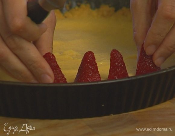 Ягоды клубники разрезать вдоль пополам и воткнуть по всей поверхности в крем.
