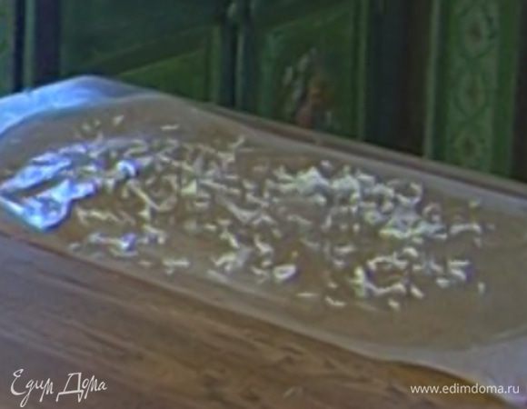 Еще один лист бумаги для выпечки смазать маслом, присыпать оставшимся пармезаном. 