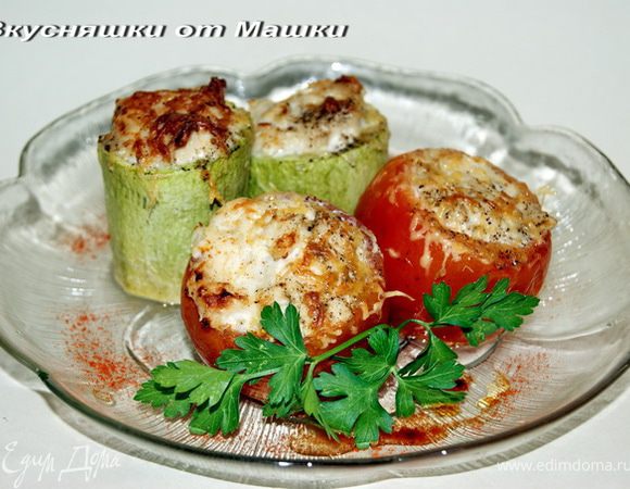 Срезав крышечки у помидор аккуратно вынимаем серединку, кабачки разрезаем на 3-4 части, и так же не до конца вынимаем мякоть. На мясорубке или в комбайне перемалываем куриное филе с чесноком, луком, солим, перчим. Начиняем наши подготовленные овощи фаршем. Выкладываем в форму, смазанную растительным маслом и запекаем в духовке в течении 30 минут. За 5 минут до окончания посыпаем тертым сыром.