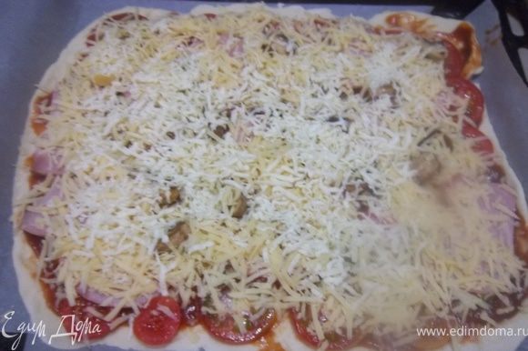 Сверху смазать тонким слоем томатной пасты, затем выложить грибы, ветчину и нарезанные кружочками помидоры. Посыпать натертым сыром.