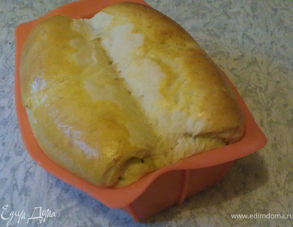 Поcле того как тесто увеличится в объеме в 2-3 раза, раскатать его в прямоугольник и нанести начинку. ( Так увлеклась процессом, что фотографии сделать забыла)
Затем взять за один край (с короткой стороны) и свернуть рулетом до центра. то же сделать с другим краем.
Форму застелить пекарской бумагой и аккуратно вложить в нее рулет. Не повторяйте моей ошибки: не используйте силиконовые прямоугольные формы - ее "разорвет" в разные стороны если только у нее не жесткий каркас.
Поставить в теплое место, чтобы тесто поднялось, примерно на 20 минут. Смазать сверху желтком. Можно сделать поперечные неглубокие насечки, но это не обязательно.
Отправить форму в разогретую до 170С духовку и выпекать 30-40 минут.