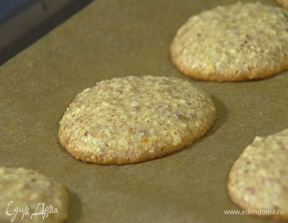 Выстелить противень бумагой для выпечки, смочить столовую ложку в воде и выкладывать небольшие лепешки из теста на некотором расстоянии друг от друга.
