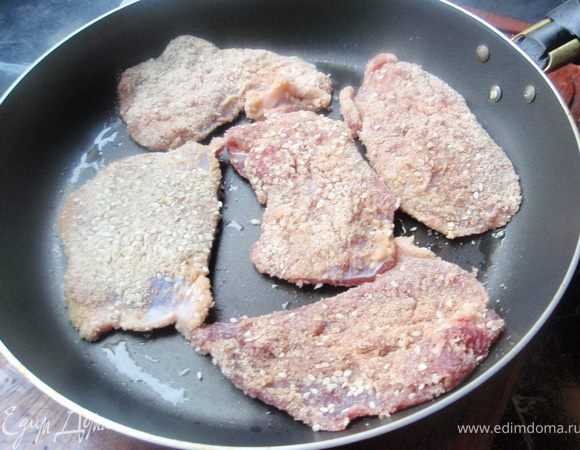 Смешаем хлебную крошку и кунжут. Обваляем мясо и отправим на хорошо разогретую сковороду с добавлением растительного масла. Обжарим с каждой стороны по 8-10 минут. При необходимости можно накрыть крышкой в последние минуты.