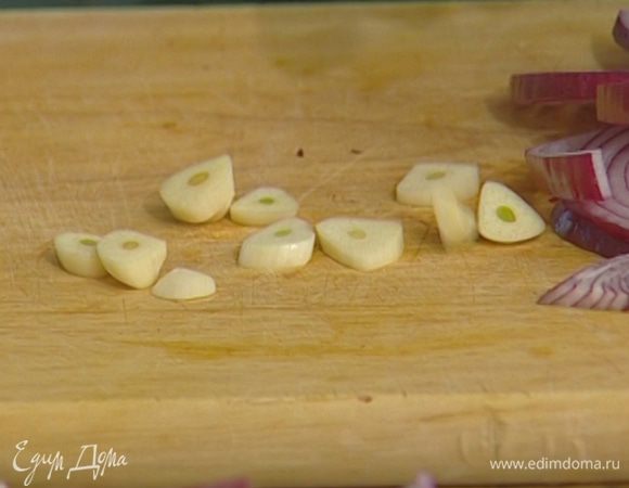 Лук и чеснок почистить, лук нарезать полукольцами, а чеснок — тонкими пластинками.