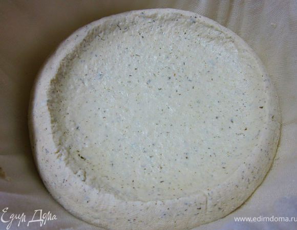 Дуршлаг выложить 4 слоями марли и вылить в него сырную смесь. Накрыть крышкой и дать остыть немного и стечь сыворотке.