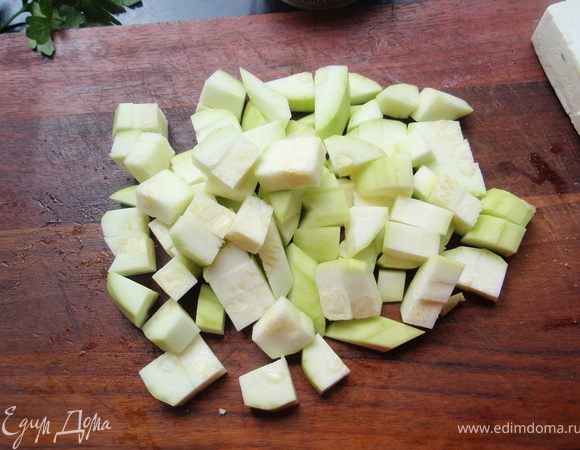 Кабачок нарежем на небольшие кубики и обжарим немного на масле. Минут 5. Накроем крышкой и оставим на маленьком огне на 10 минут. При необходимости добавим немного воды. 