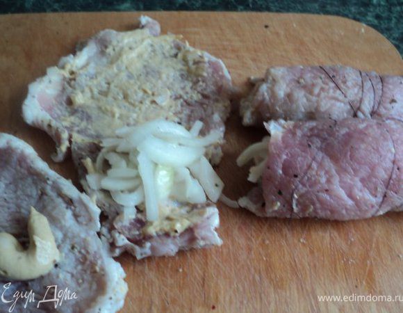 Мясо вынуть из маринада, одну сторону смазать горчицей, положить сверху маринованый лук, свернуть рулетиком. Обмотать рулетик ниткой.