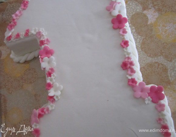 Украсить по желанию.
По бортику прикрепить жгутик.
По краю единички, на айсинг прикрепить маленькие цветочки.