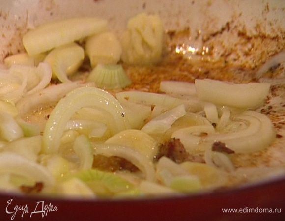 В кастрюлю, где жарилось мясо, добавить, если нужно, еще немного оливкового масла и обжарить лук и чеснок до легкого золотистого цвета. 