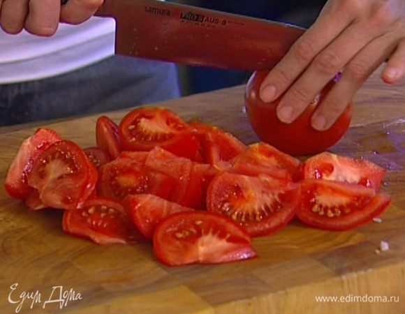 Помидоры нарезать крупными дольками, добавить к луку и чесноку.