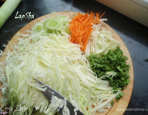 Пока фарш отдыхает, займемся начинкой. Для этого нам надо нашинковать лук-порей, сельдерей, зелень и капусту довольно тонко. Морковь либо натереть на терке, либо нарезать тонкими полосочками, как я и сделала.