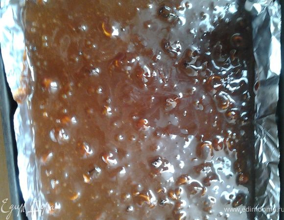 Орехи и чернослив добавить в шоколадную смесь, перемешать и влить в форму, застланную фольгой. 