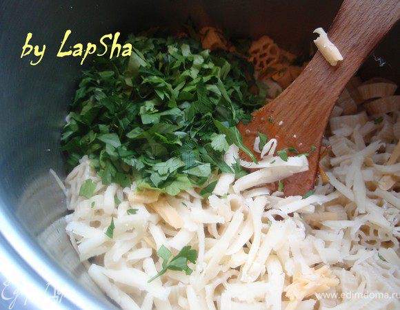 Тем временем отварить макароны в посоленной воде с добавлением растительного масла. В готовую пасту добавить мелко порубленную петрушку и половину сыра.