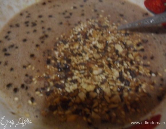 К яичной массе добавить растопленную шоколадную смесь, влить вино, всыпать орех.