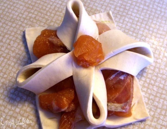 Соединить противоположные уголки слоечки и придавить соединение кусочком рыбки.