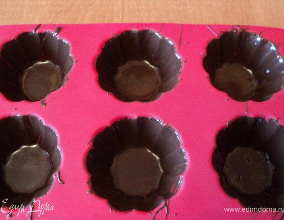 Кисточкой смазать шоколадом силиконовые формочки для мафинов, поставить в морозилку для застывания на 10мин.