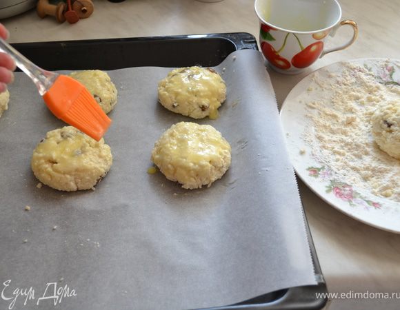 Из теста сформировать небольшие лепешки и каждый обвалять в муке. Выложить сырники на противень. Смазать вторым желтком. 