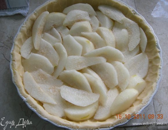 Размять руками тесто по форме, сделать бортик. 

Тонко нарезать груши и равномерно разложить поверх теста. 
