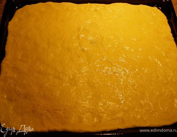 Моццареллу натрем на крупной терке. тем временем тесто подошло. Тесто раскатаем по величине противня, толщиной около 5 мм. Сбрызнем оливковым маслом, чтобы не намокало от жидкой начинки