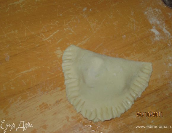 Сложить лепёшку пополам и защипить края. Я сначла залипляла прижимая к столу края лепёшки, а потом края залепляла зубьями вилки.