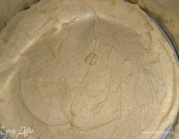 Форму застелить пергаментом и равномерно распределить по ней тесто.