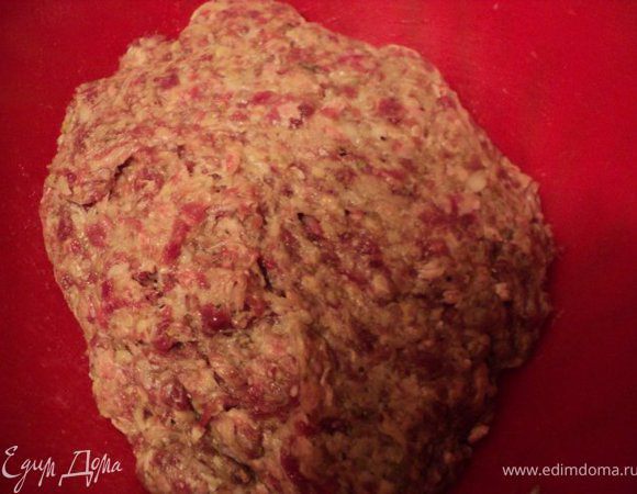 В фарш добавить натертые сырой картофель, ½ луковицы, соль, специи по вкусу, хорошо перемешать, немного выбить.