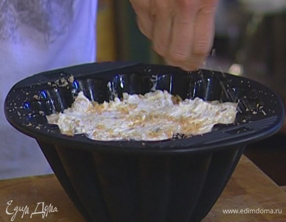 Сверху равномерно распределить крем из рикотты, посыпать оставшейся крошкой из печенья и орехов.