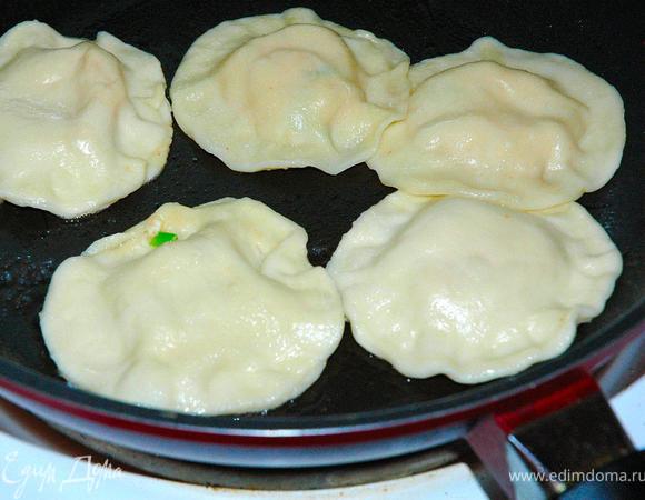 Пришло время готовить наши вонтоны. Берем сковородку, хорошенько разогреваем ее, выливаем столовую ложку растительного масла и полкружки (около 100мл) воды. Раскладываем вонтоны и накрываем крышкой. Как только вода выпарится и вонтоны начнут обжариваться, перевернем их лопаткой и обжарим с двух сторон и так каждую партию.