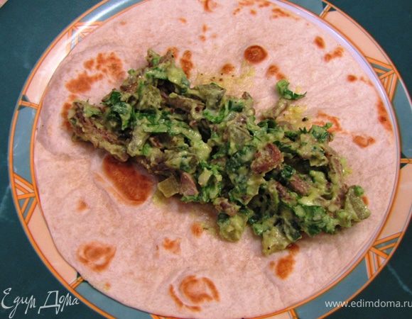 Положите начинку на теплую тортилью.