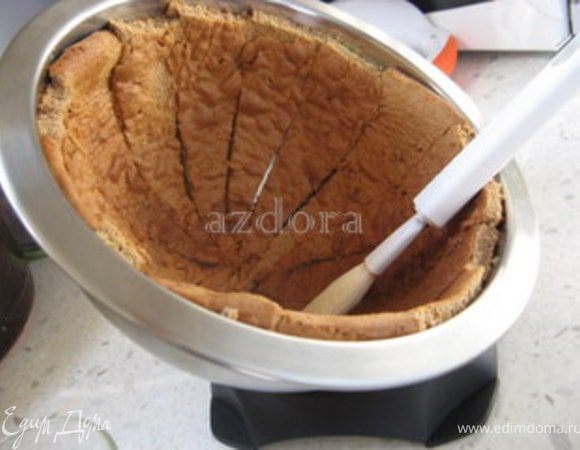 Затем нужно пропитать корж. В этом рецепте я использую кокосовый ликёр. Моя форма ставится под любым углом, что облегчает мне задачу. Кисточкой промазываю кусочки бисквита один за другим, наклоняя и поворачивая форму.