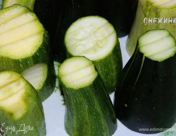 У кабачков отрезать кончики и разрезать каждый пополам поперек. Поставить половинки на ровное основание (на место разреза), у каждой половинки сделать по три надреза практически до основания, оставляя до основания столько, чтобы половинки не распадались (где-то около 1 см.). Посолить кабачки, в том числе внутри надрезов, слегка разжимая их. Оставить. 