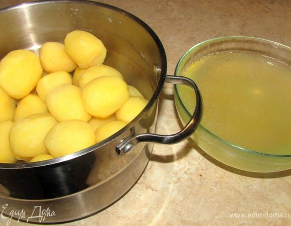 Когда вода закипит - немного посолите воду, убавьте огонь до маленького и накройте крышкой.
Варите картофель 40 минут. Проверьте картофель на готовность, проткнув самый большой клубень тонким ножом. Если лезвие ножа заходит мягко и с одинаковым усилием по всей толщине картофеля - он готов.
Слейте воду, в котором готовилась картошка в емкость.