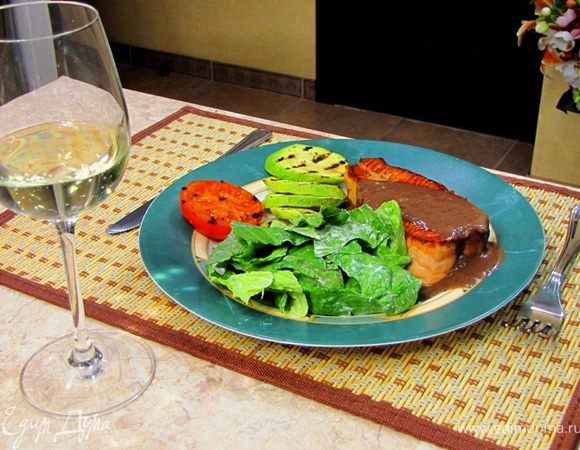Выложите семгу на тарелку. Полейте сверху приготовленным соусом.
Рядом положите заправленный салат, половинку помидора и жаренные кабачки.