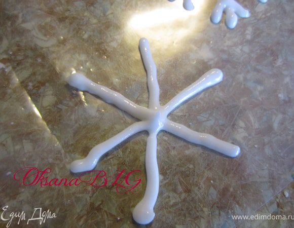 С помощью корнетика или кондитерского мешочка нанести узор снежинки на пергаментную бумагу, смазаную маслом или на файлик.