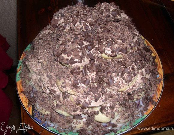 Формируем тортик так,как вам нравится.Сверху обливаем оставшимся кремом,посыпаем орешками и украшаем тертым шоколадом.
Можно облить глазурью,это на ваш выбор.