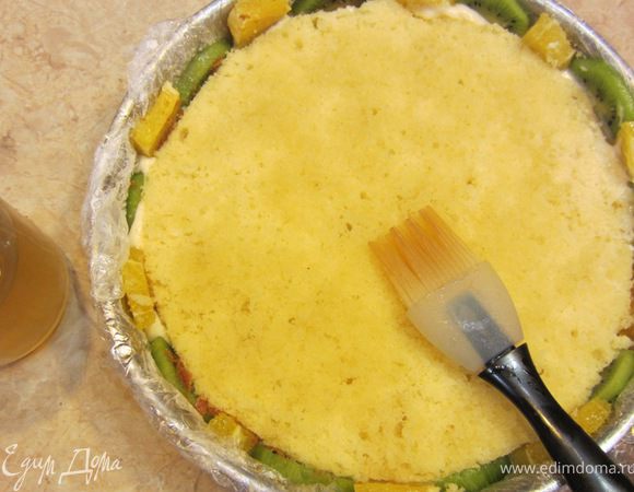 Теперь кондитерской кисточкой хорошенько смажьте корж сиропом с апельсиновым соком и ликером (или хересом), который мы ранее подготовили.